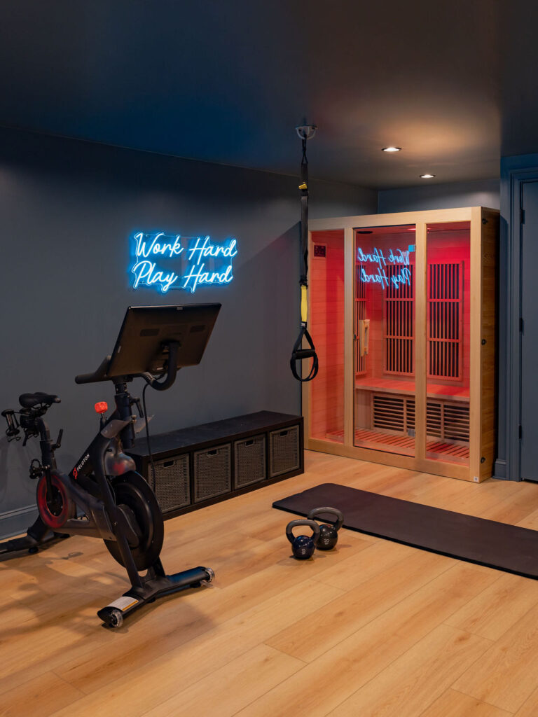 Home gym basement with infrared sauna and neon sign in Ridgefield Connecticut